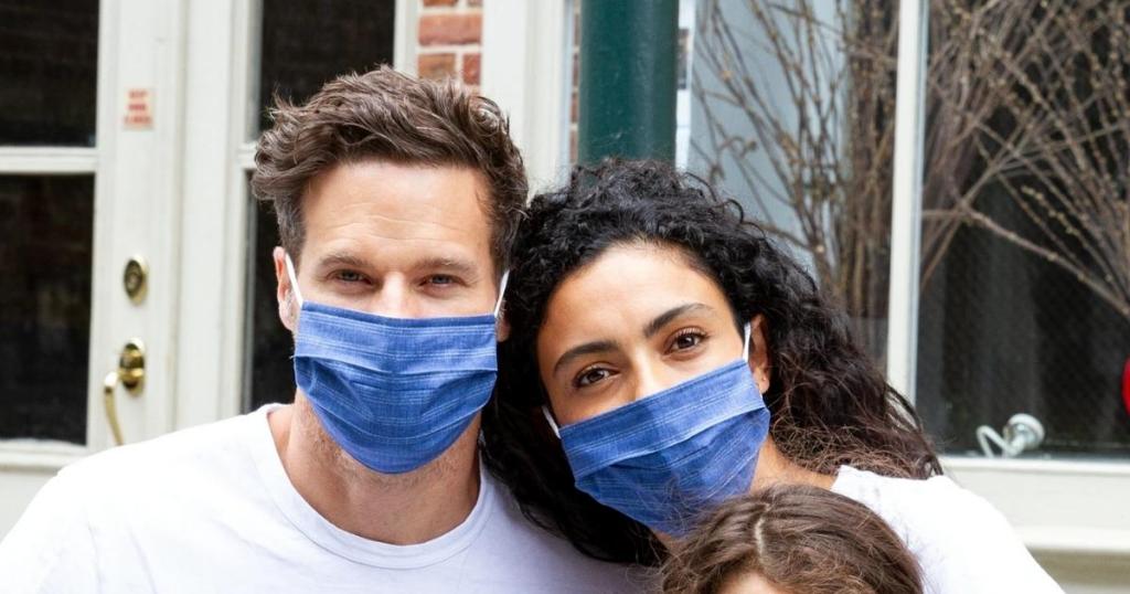 man and woman wearing blue face masks from gap