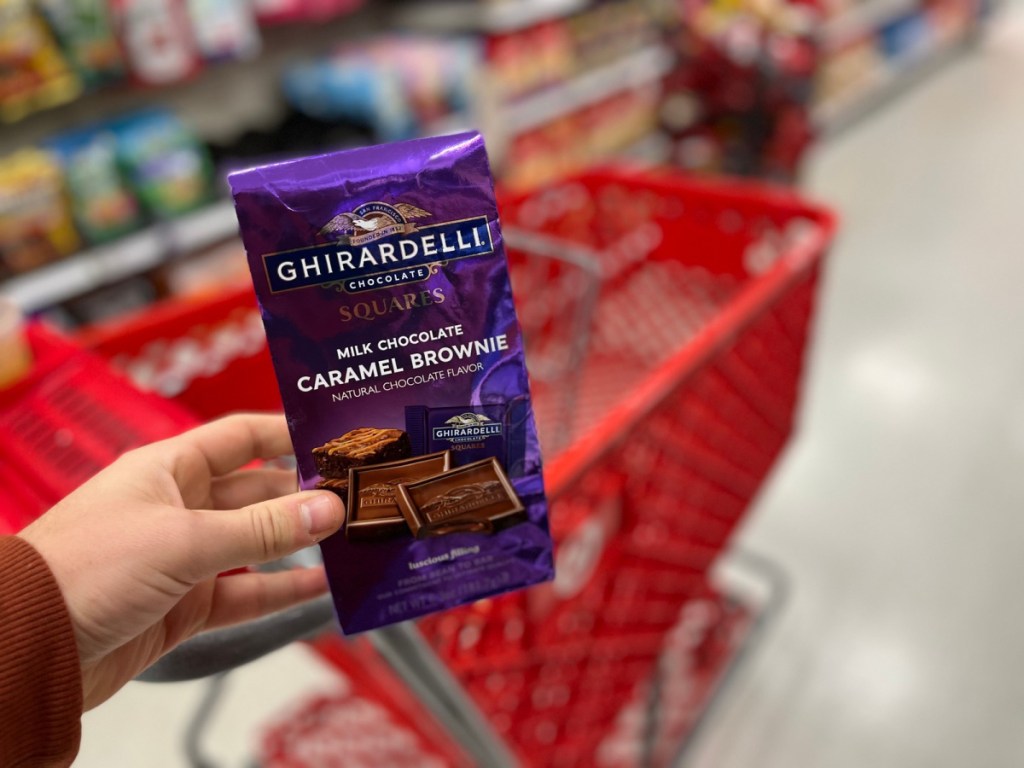 man holding a bag of Ghirardelli chocolates