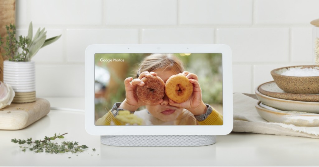 smart display on kitchen counter showing photo of girl holding donuts