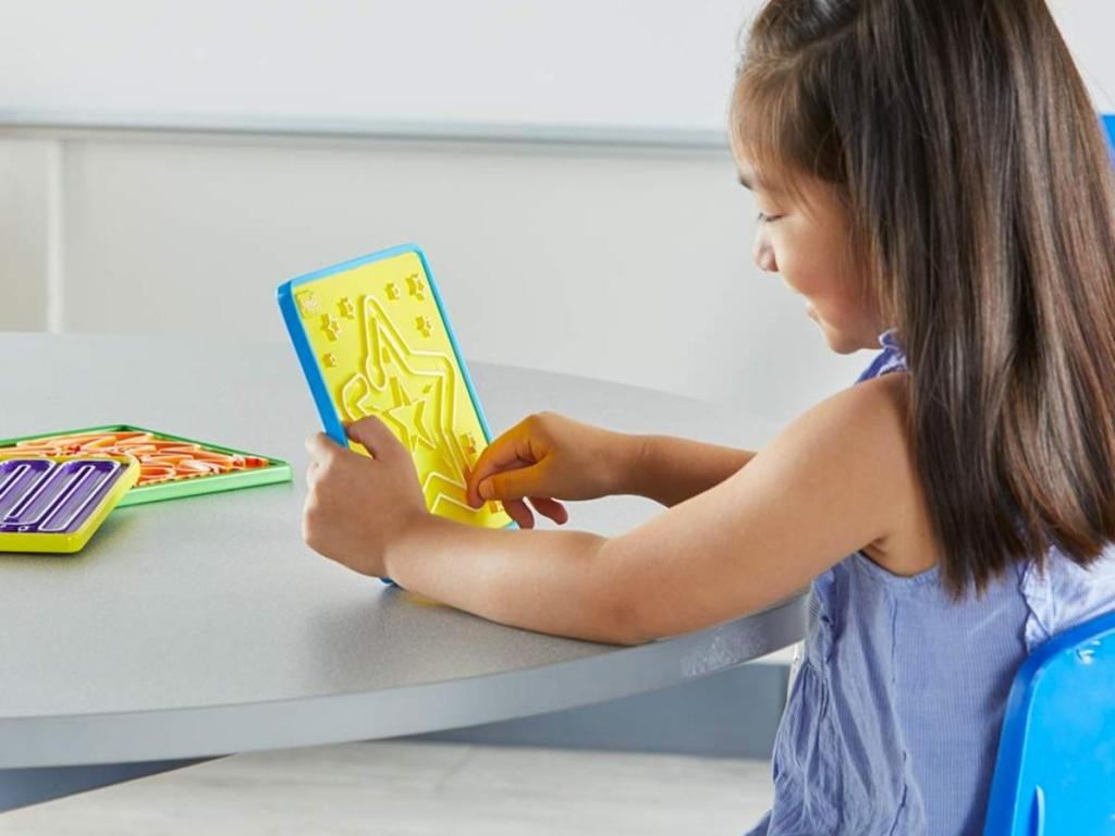girl playing with hand2mind mindful maze boards