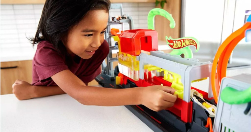 girl playing with toy car wash 