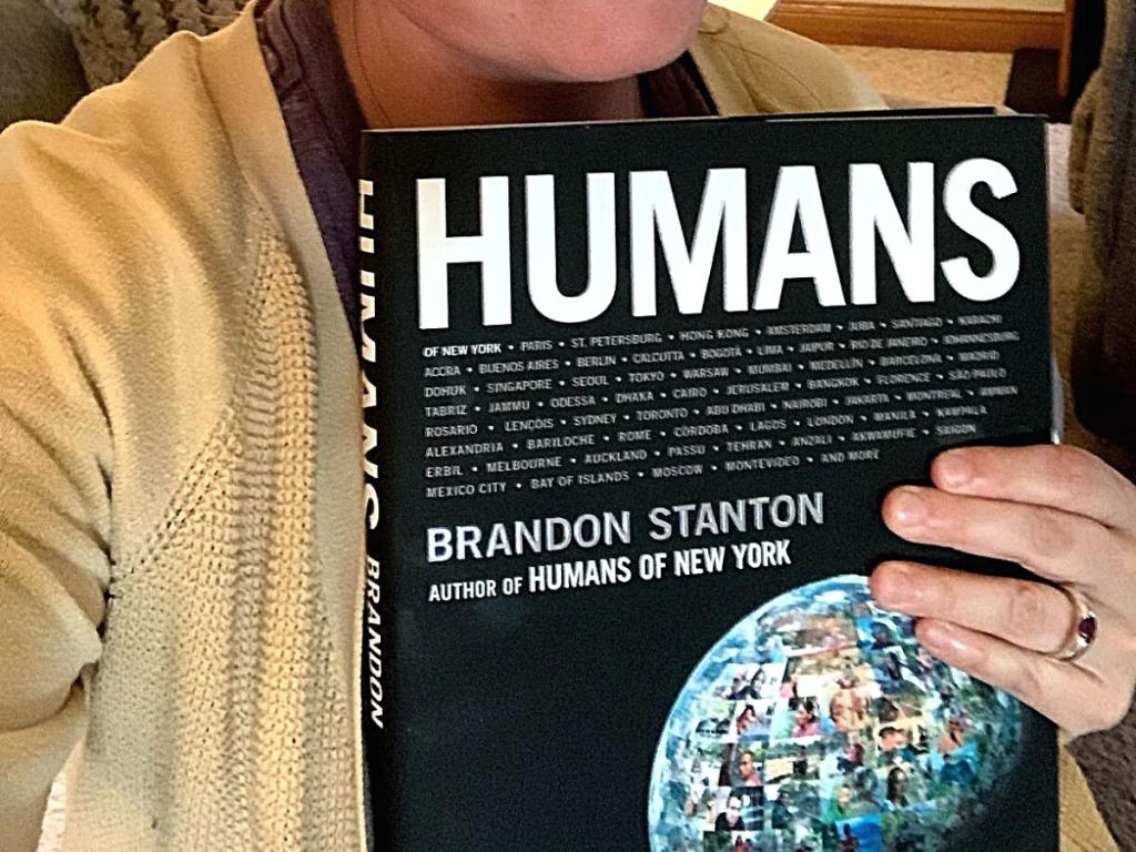hand holding HUMANS hardcover book