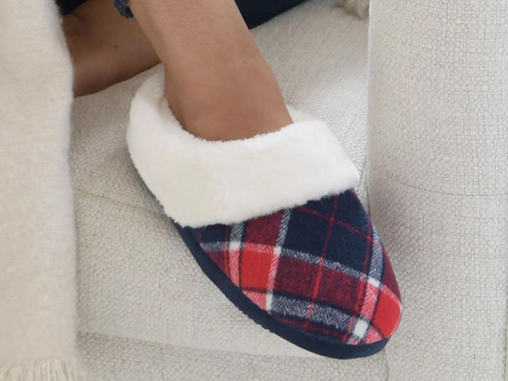 Person sitting on a chair wearing an Isotoner Plaid Slipper