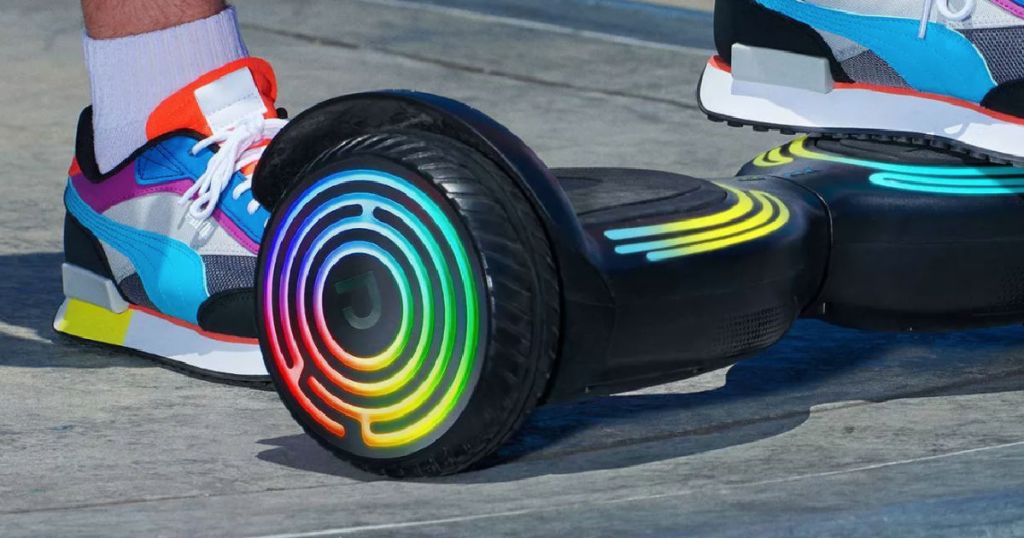 foot on rainbow colored hoverboard 