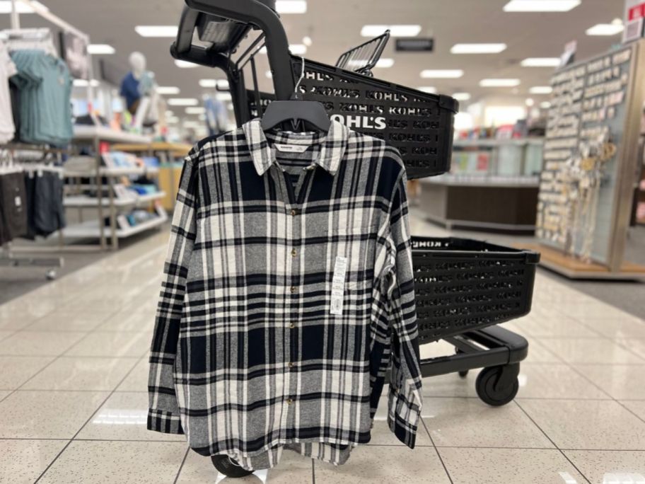 A black & White Plaid Sonoma Women's Plaid Flannel shirt hanging on a shopping cart at Kohl's