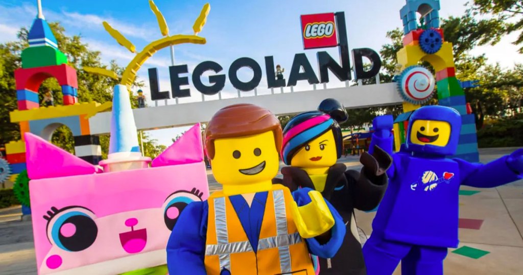 legoland sign with characters in front of it
