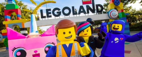 legoland sign with characters in front of it