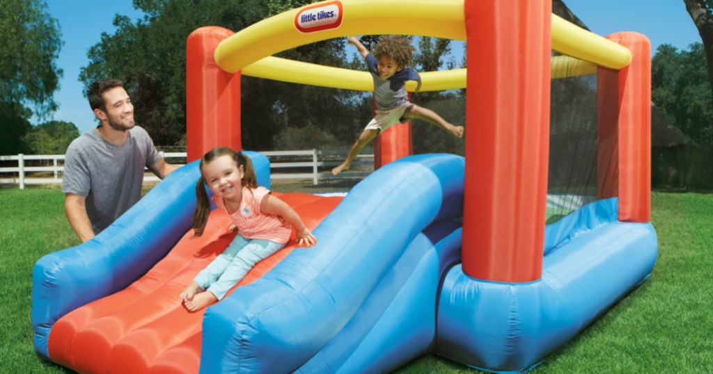 boy and girl playing in inflatable bounce house