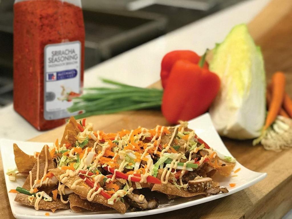 nacho chips with mccormick sriracha seasoning on food and in background