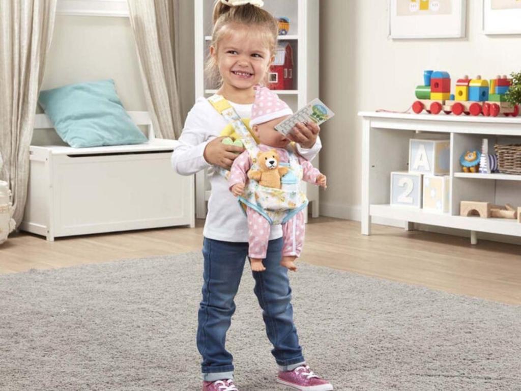girl with baby doll in melissa and doug doll carrier