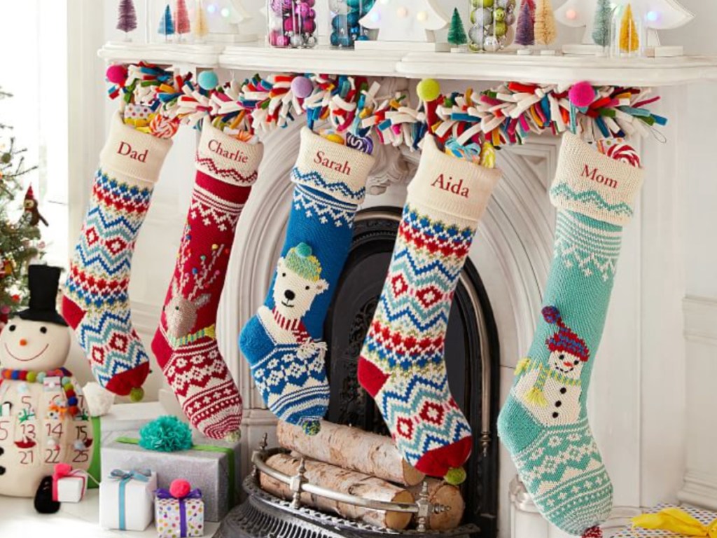 brightly colored christmas stockings hanging from mantel