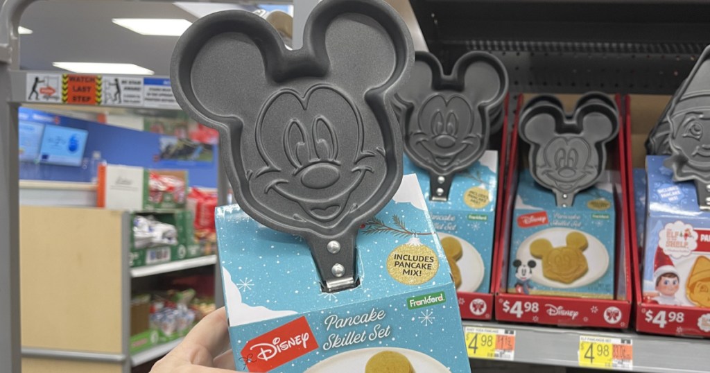 hand holding small skillet with Mickey Mouse's face in a store