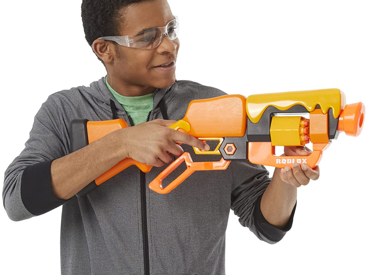 boy holding large orange toy blaster