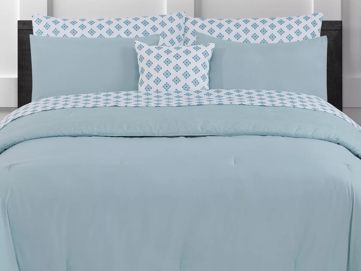 teal bedding on bed