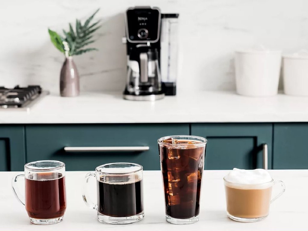 countertop with four different kinds of coffee poured in cups