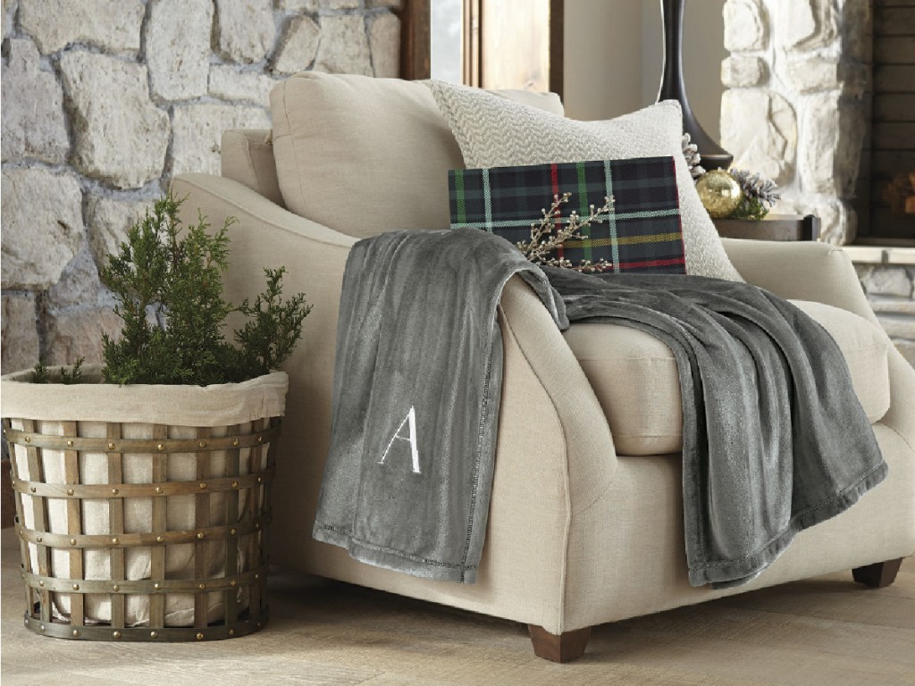 gray monogram velvet throw blanket on chair in home