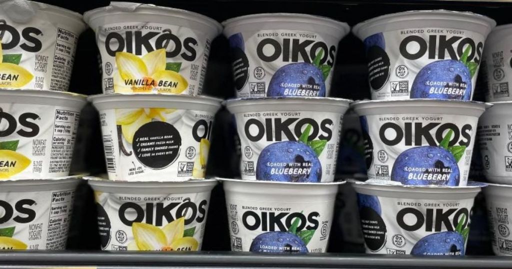 oikos blended vanilla bean and blueberry yogurts stacked on display in store