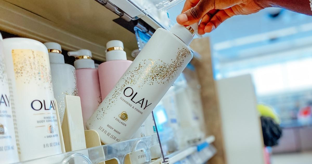 hand holding olay cleansing and firming body wash in store