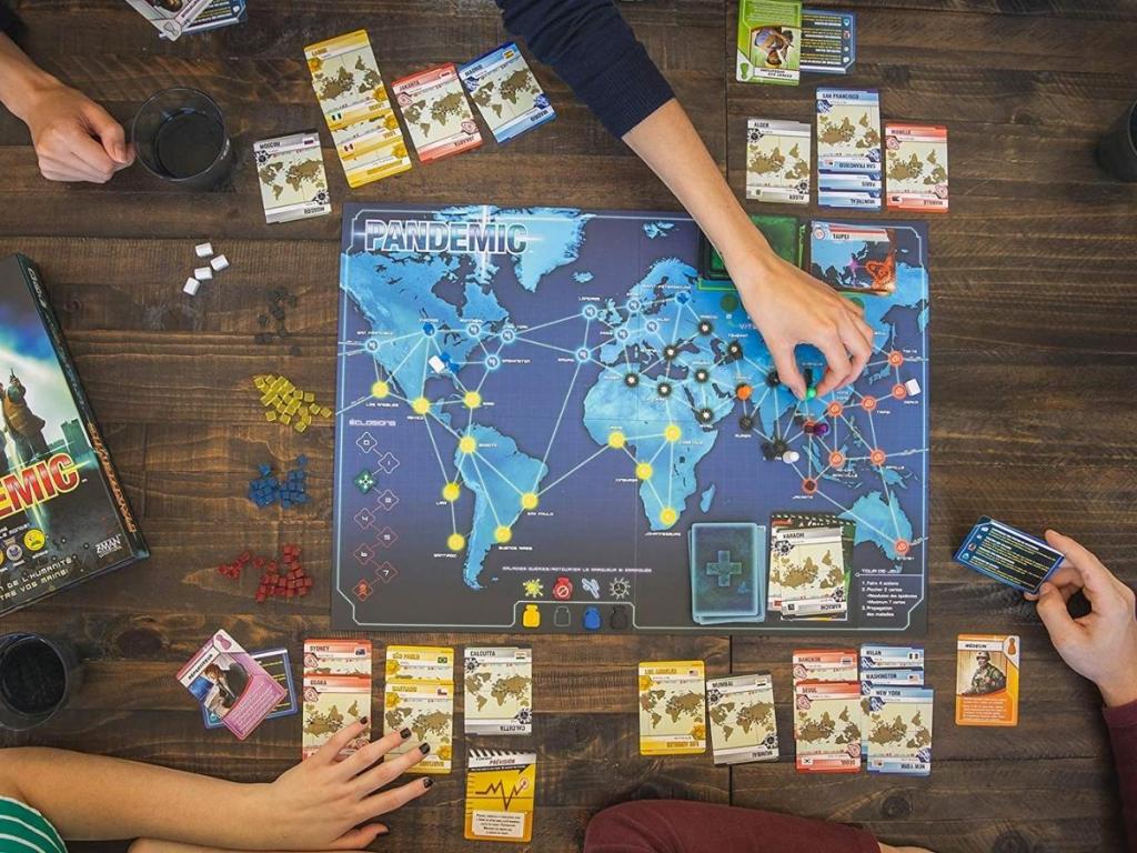 pandemic board game setup with people playing