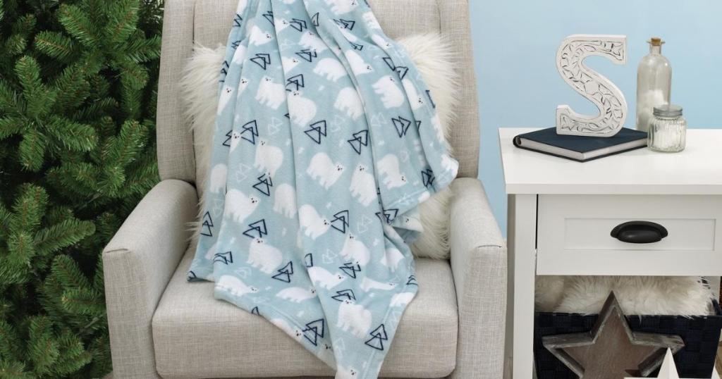 parent's choice blue polar bear baby blanket draped over chair