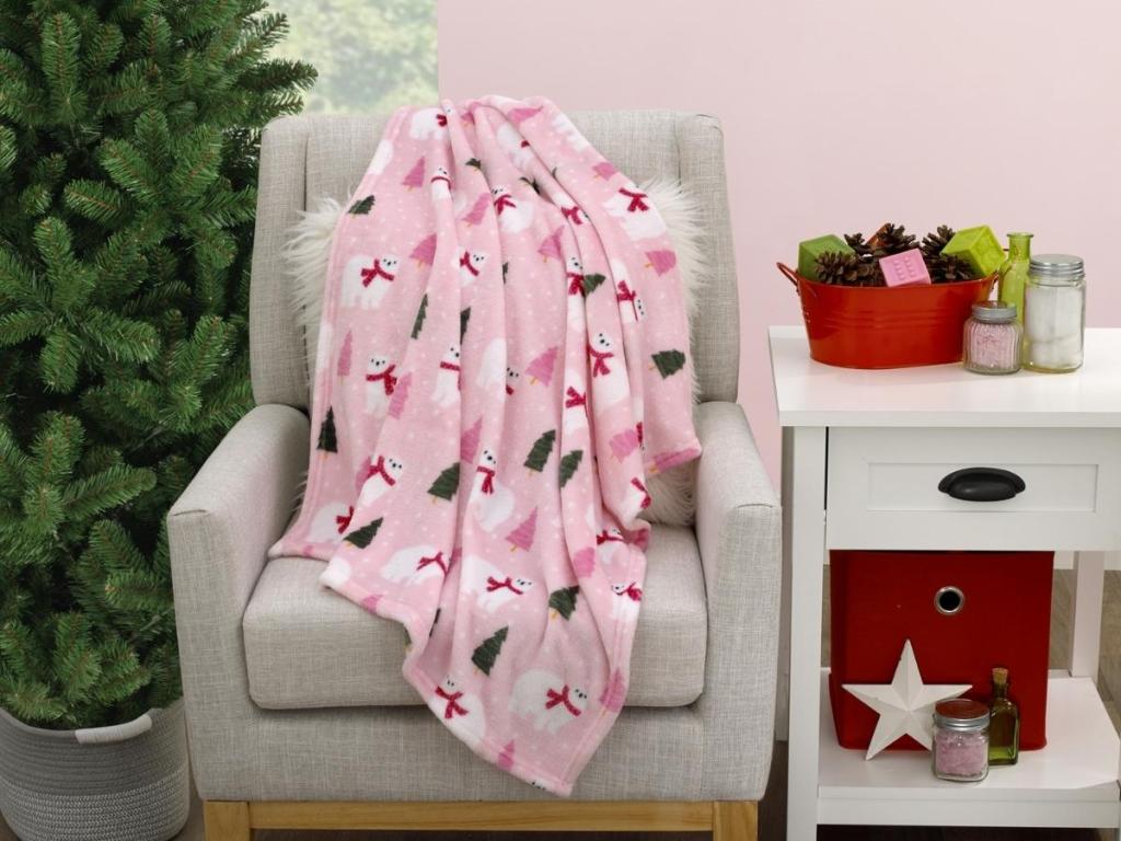 parent's choice pink polar bear blanket draped over chair