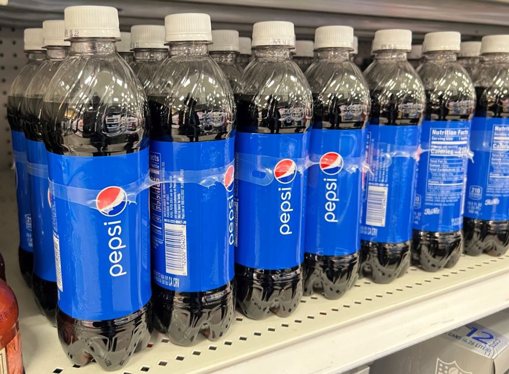 row of Pepsi bottles on a shelf
