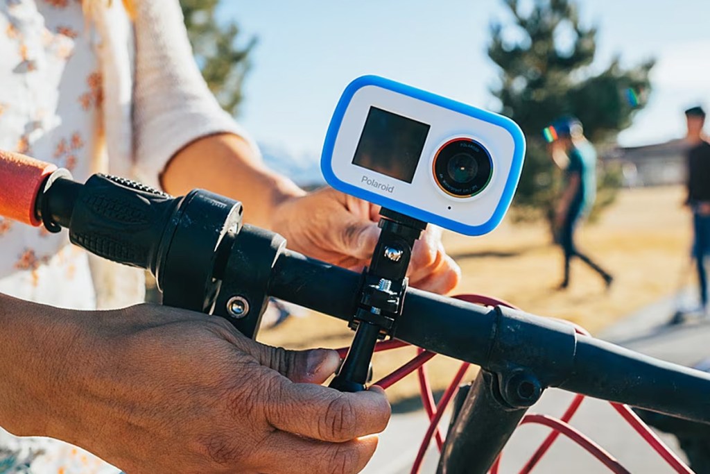 white and blue camera attached to bike