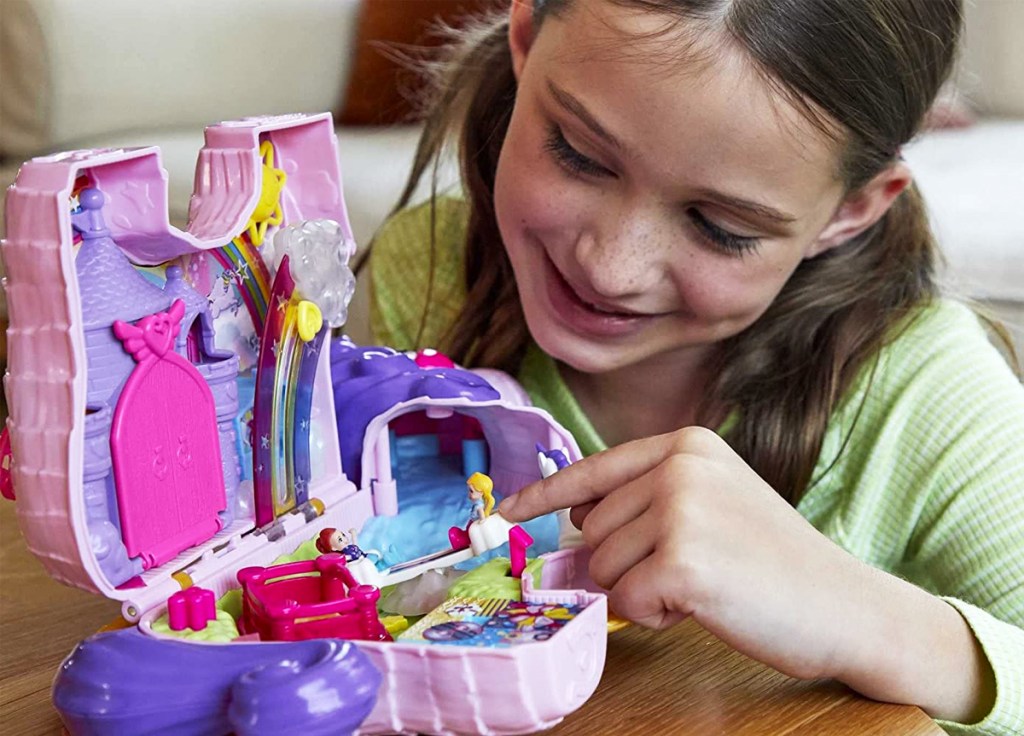 girl playing with Polly Pocket Unicorn Party Large Compact Playset