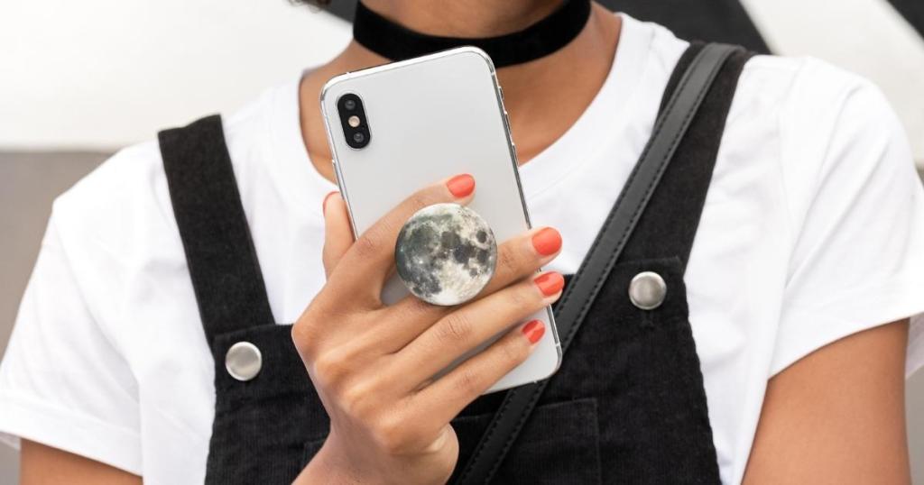 hand holding phone with popsockets popgrip moon 