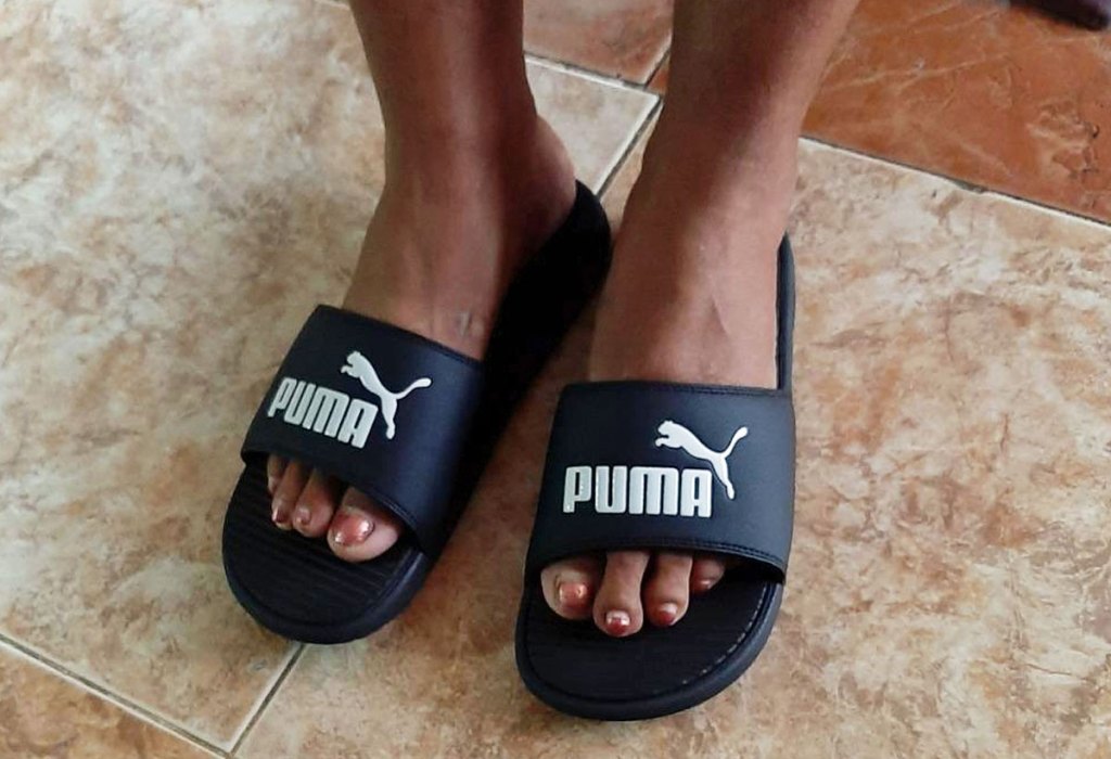wearing black puma slides
