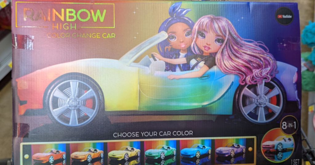 rainbow car with doll riding in it 
