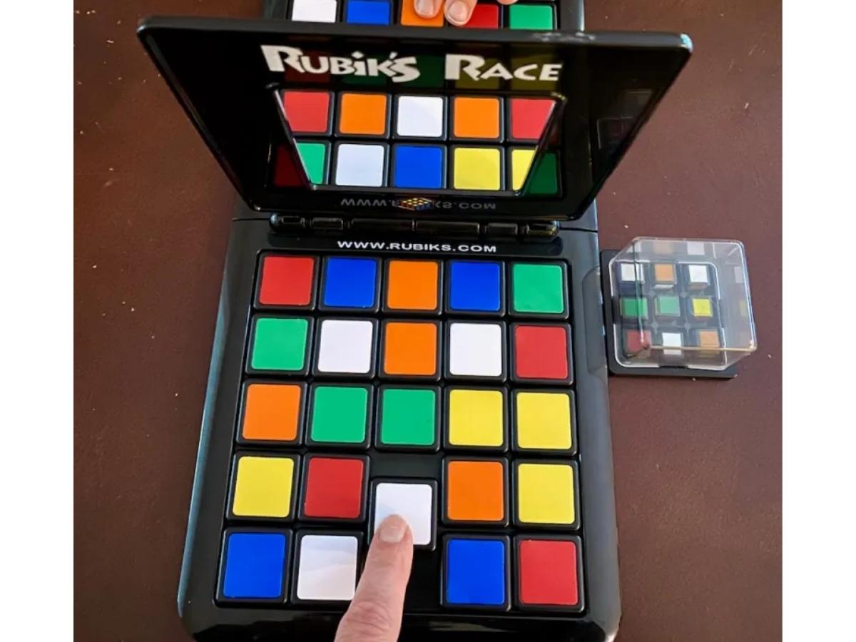 rubik's race board game with people playing