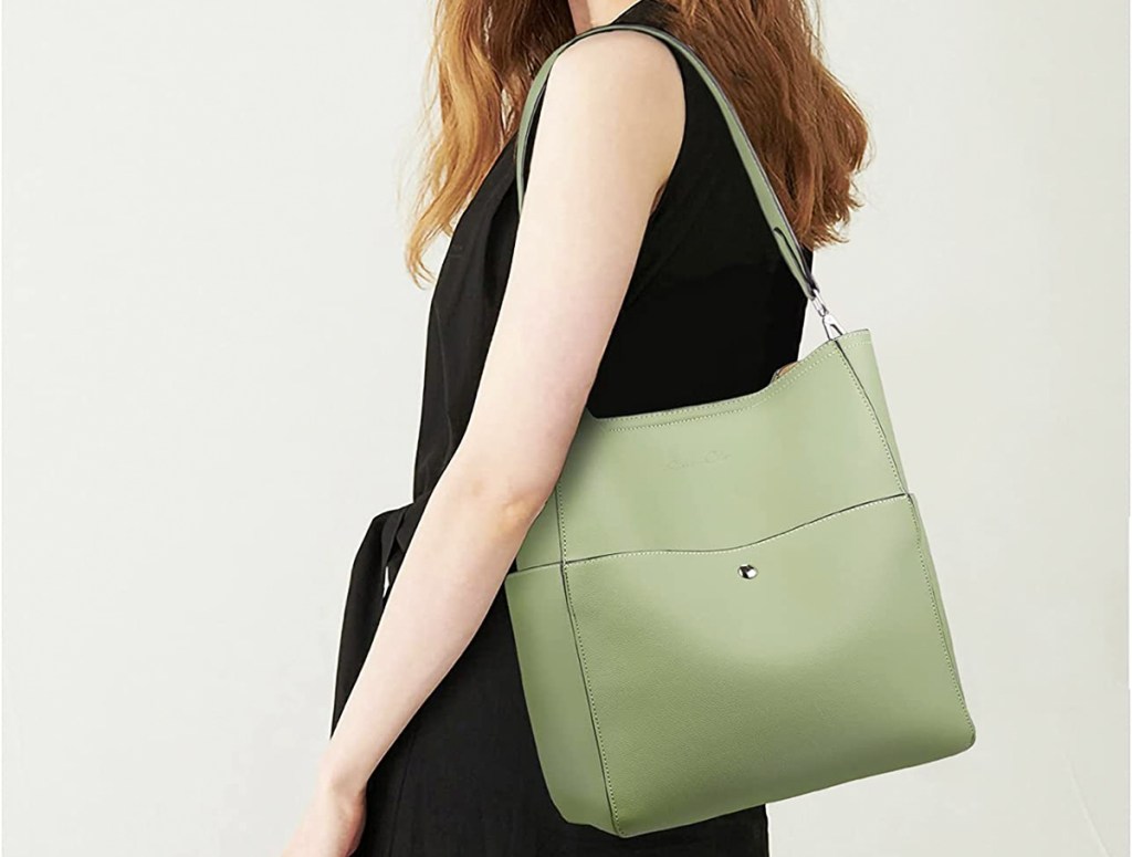 woman with green bag on shoulder