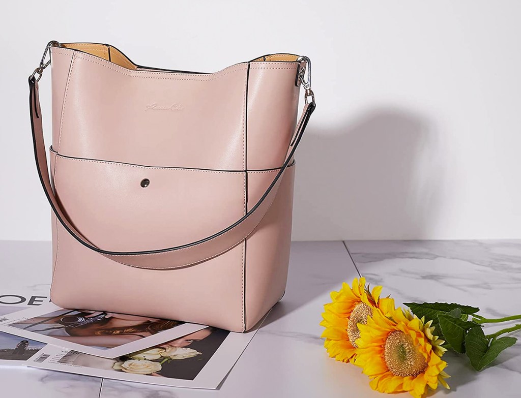 pink bucket handbag near sunflowers
