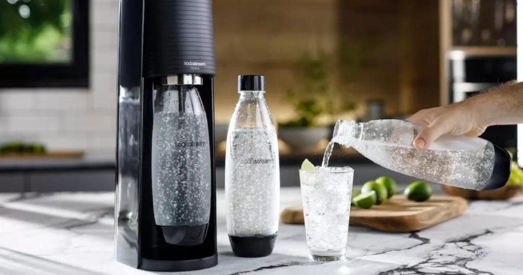 sodastream terra sparkling water maker with carbonated cylinder and glass