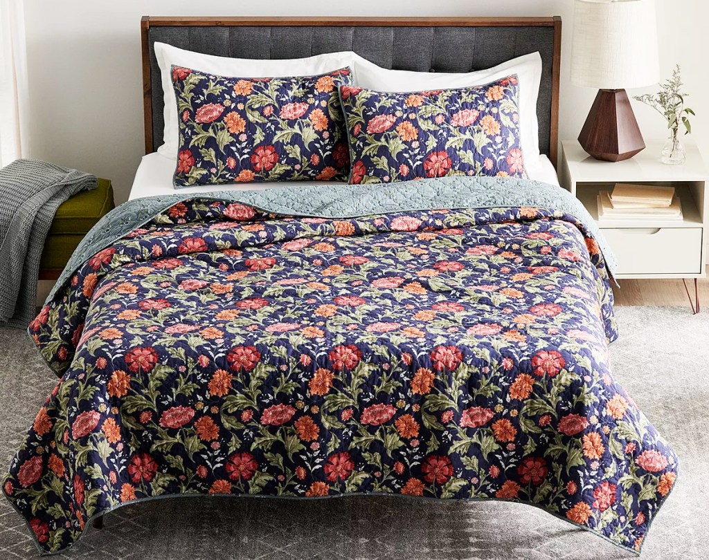 floral reversible quilt on a bed