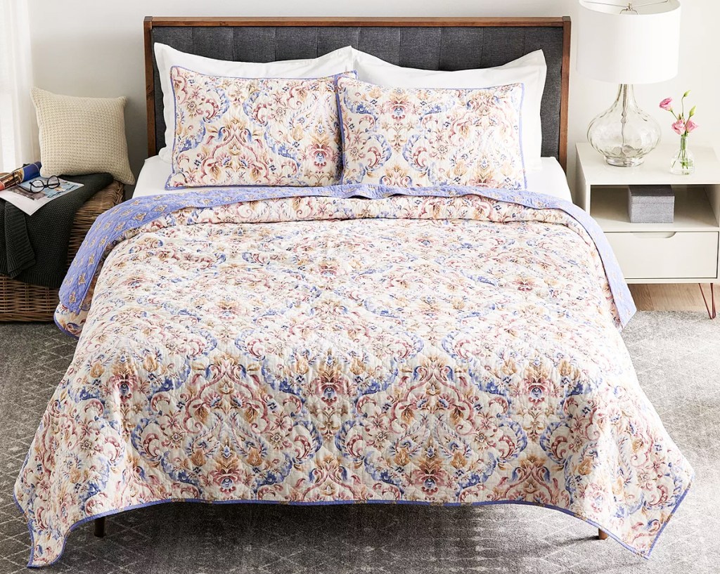 printed reversible quilt on a bed