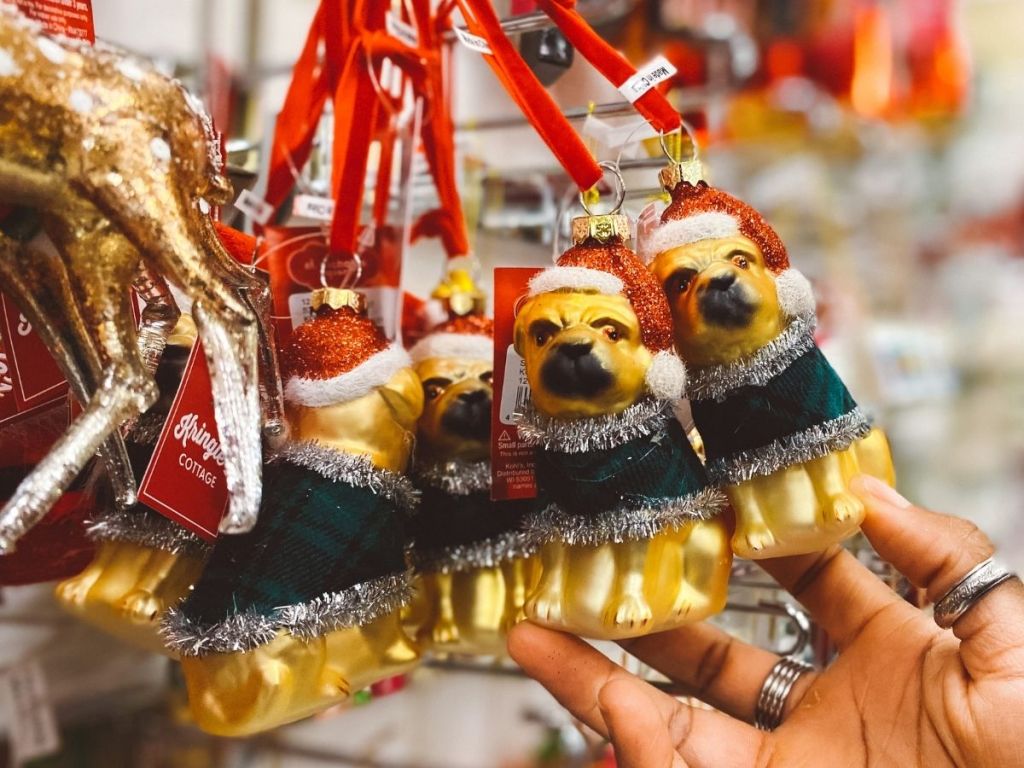 hand touching dog ornaments