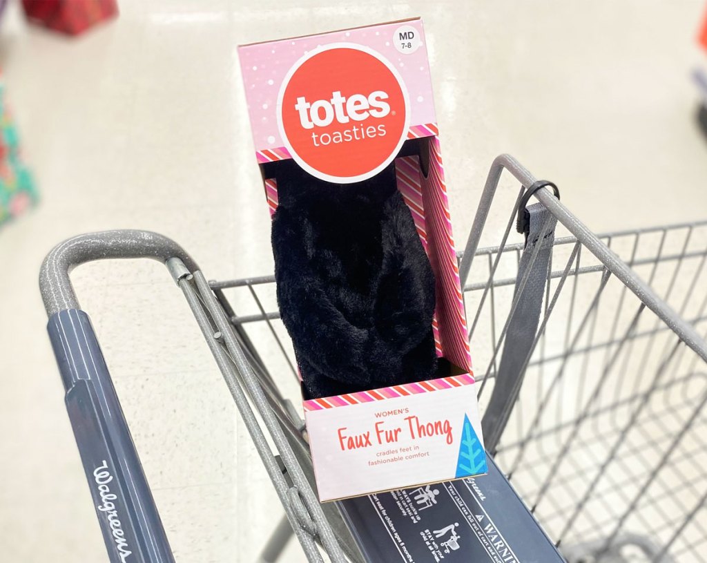 box of black slippers in shopping cart