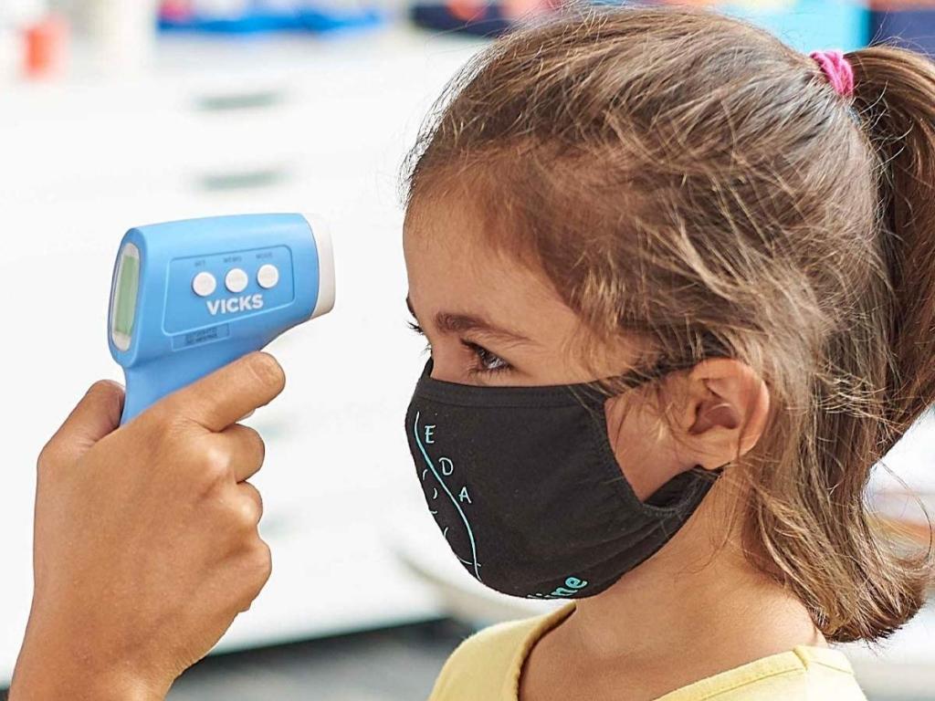 girl getting temperature taken with vicks non contact infrared thermometer