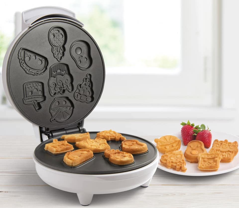 waffle maker with a plate of waffles next to it