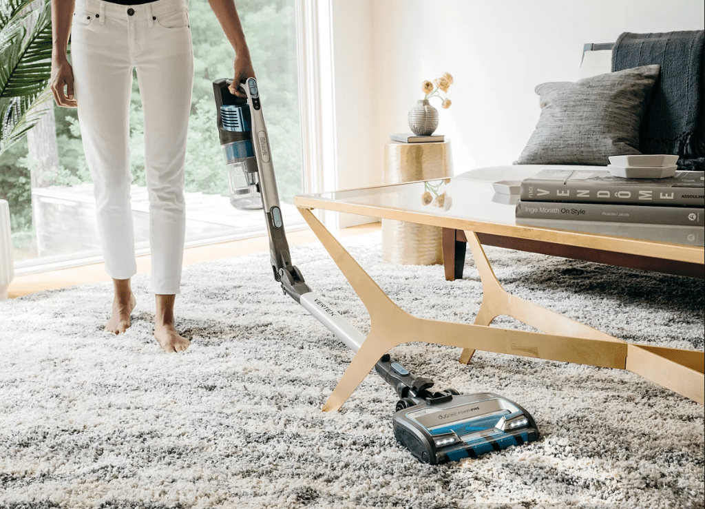 Woman Vacuuming with Shark Vertex Stick Vacuum