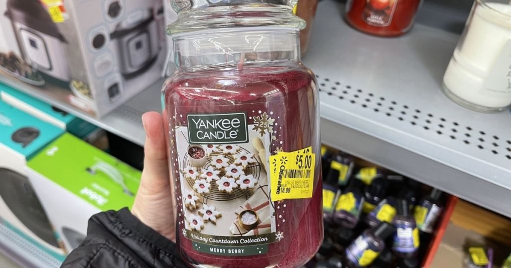 hand holding a Yankee Candle Merry Berry