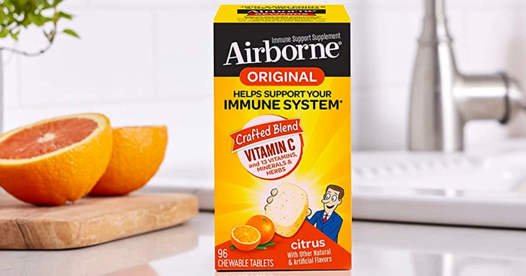 airborne vitamin c supplements on counter next to oranges