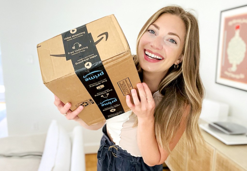 woman smiling holding Amazon box