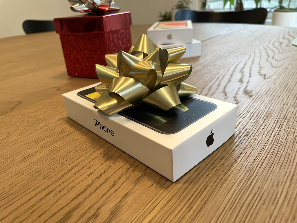 Apple iPhone gift wrapped on table 
