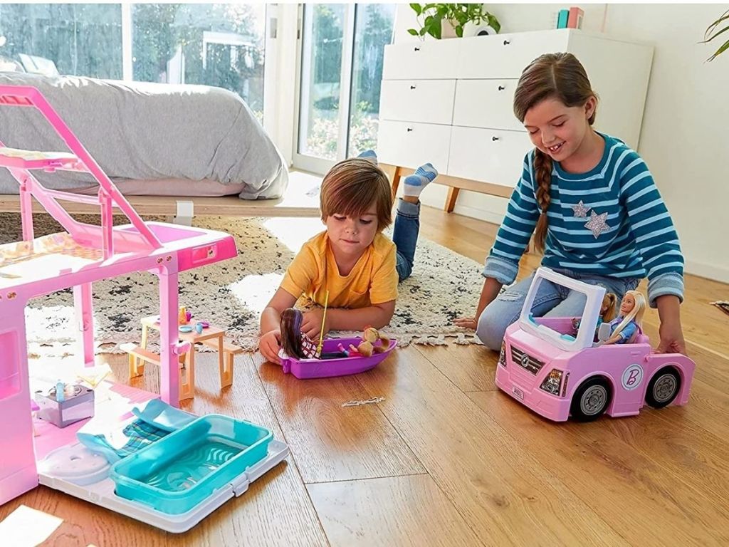 kids playing with Barbie camper