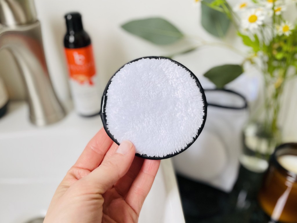 hand holding round microfiber makeup remover round
