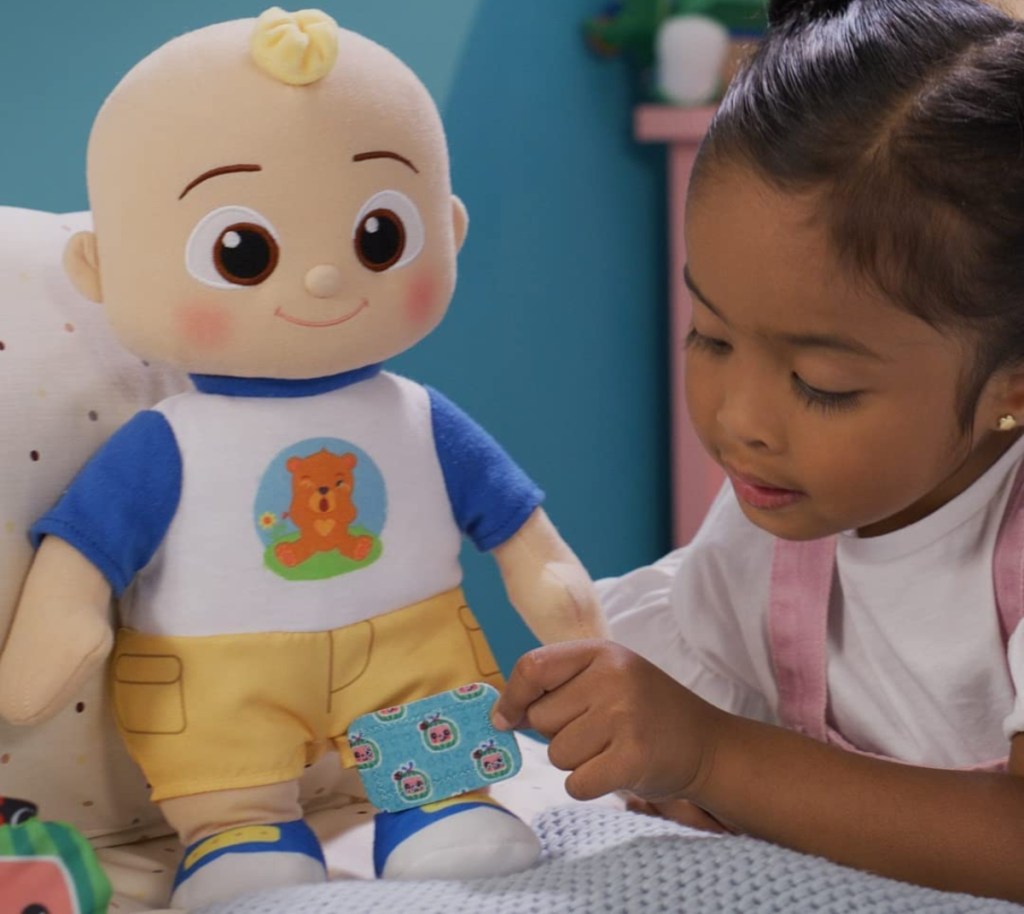 girl putting bandage on JJ doll