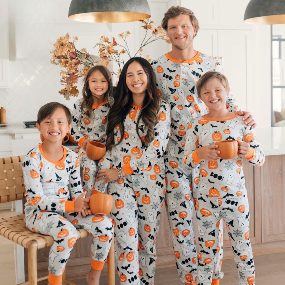 a family wearing matching halloween pajamas 